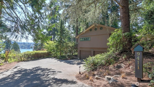9411 SE 54th St, Mercer Island, WA 98040 - view of front facade featuring driveway and an attached garage