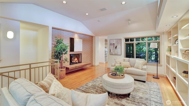 9411 SE 54th St, Mercer Island, WA 98040 - living room with vaulted ceiling, wood finished floors, a brick fireplace, and recessed lighting