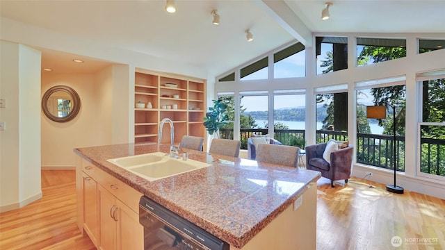 9411 SE 54th St, Mercer Island, WA 98040 - kitchen with black dishwasher, light wood finished floors, a water view, a kitchen island with sink, and open floor plan