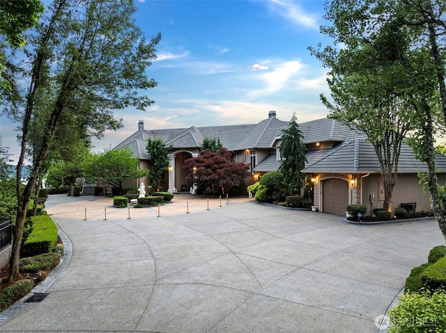 1022 7th Ct, Fox Island, WA 98333 - view of front facade featuring concrete driveway, an attached garage, and stucco siding