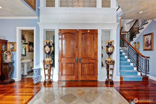 1022 7th Ct, Fox Island, WA 98333 - entryway featuring wood finished floors, stairs, and crown molding