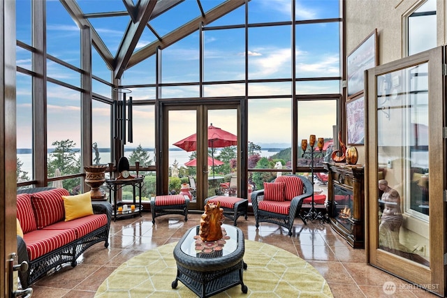 1022 7th Ct, Fox Island, WA 98333 - sunroom / solarium with a wall of windows, plenty of natural light, a towering ceiling, and tile patterned floors