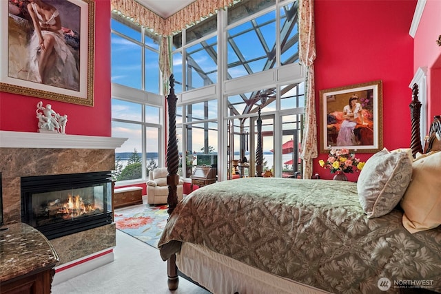 1022 7th Ct, Fox Island, WA 98333 - carpeted bedroom with a high ceiling and a multi sided fireplace