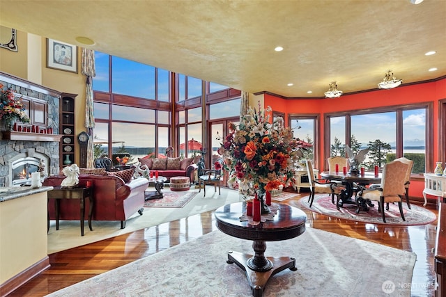 1022 7th Ct, Fox Island, WA 98333 - living area featuring wood finished floors, a stone fireplace, and recessed lighting