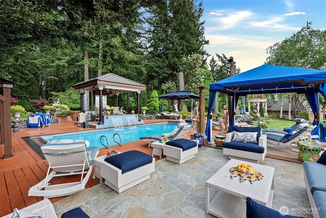 1022 7th Ct, Fox Island, WA 98333 - swimming pool with a gazebo, a wooden deck, outdoor lounge area, and an outbuilding