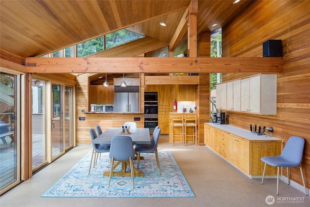 69 Rocky Rd, Crane Island, WA 98245 - dining space with wooden walls, plenty of natural light, light colored carpet, wood ceiling, and high vaulted ceiling