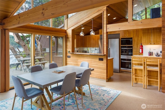 69 Rocky Rd, Crane Island, WA 98245 - dining space featuring high vaulted ceiling, wood ceiling, and wood walls