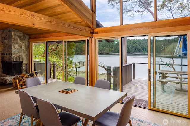 69 Rocky Rd, Crane Island, WA 98245 - dining area with beamed ceiling, a water view, and a fireplace