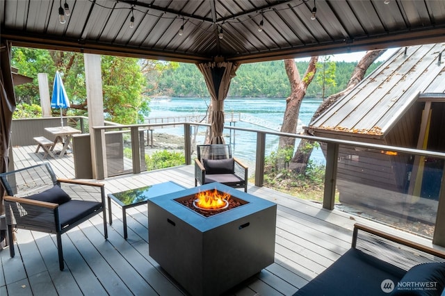 69 Rocky Rd, Crane Island, WA 98245 - wooden terrace featuring an outdoor fire pit and a water view