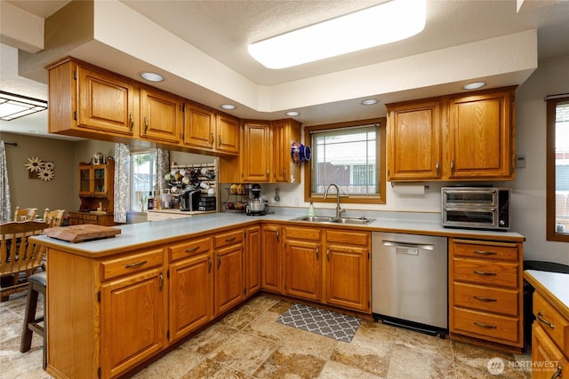 1130 Central Dr, Coulee Dam, WA 99116 - kitchen with dishwasher, brown cabinetry, light countertops, and recessed lighting