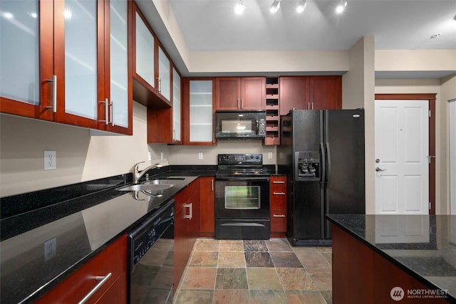 259 W Bakerview Unit 304, Bellingham, WA 98226 - kitchen featuring black appliances, dark stone countertops, stone finish flooring, and glass insert cabinets