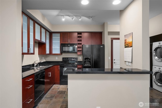 259 W Bakerview Unit 304, Bellingham, WA 98226 - kitchen featuring black appliances, stacked washer / dryer, dark countertops, open shelves, and reddish brown cabinets