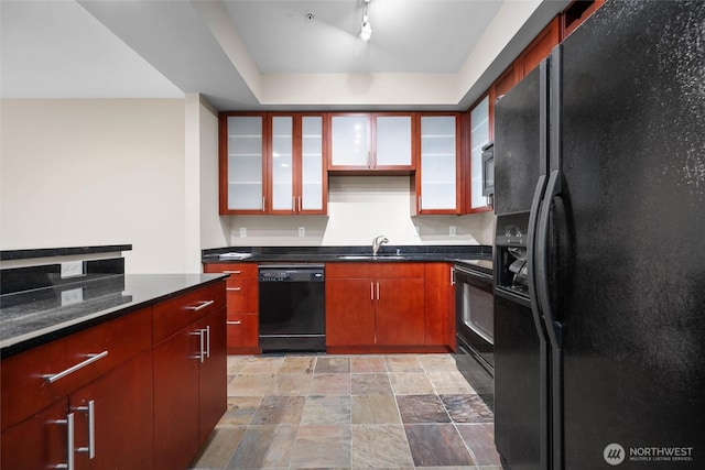 259 W Bakerview Unit 304, Bellingham, WA 98226 - kitchen with black appliances, dark countertops, stone finish floors, and glass insert cabinets