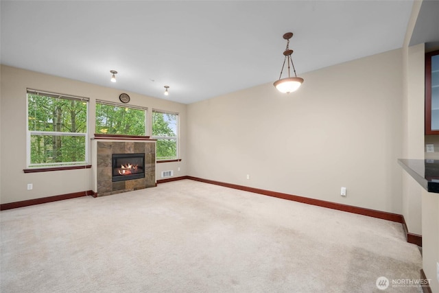 259 W Bakerview Unit 304, Bellingham, WA 98226 - unfurnished living room featuring carpet floors and a tiled fireplace
