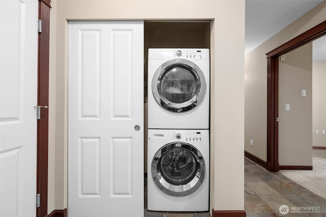 259 W Bakerview Unit 304, Bellingham, WA 98226 - washroom featuring stacked washing machine and dryer and baseboards