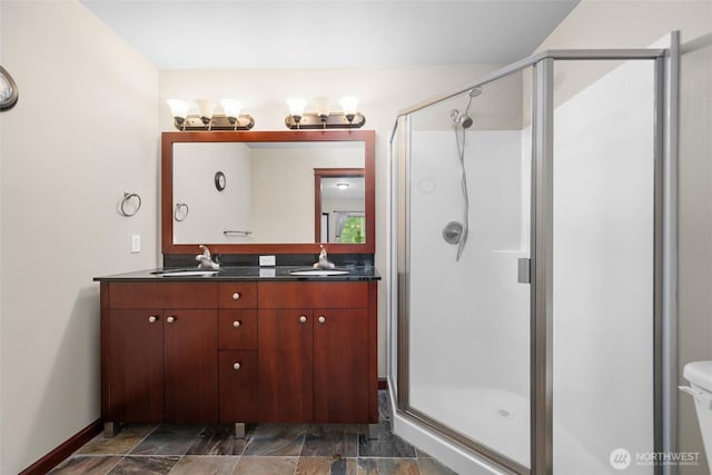 259 W Bakerview Unit 304, Bellingham, WA 98226 - full bathroom featuring a stall shower, double vanity, and stone finish floors