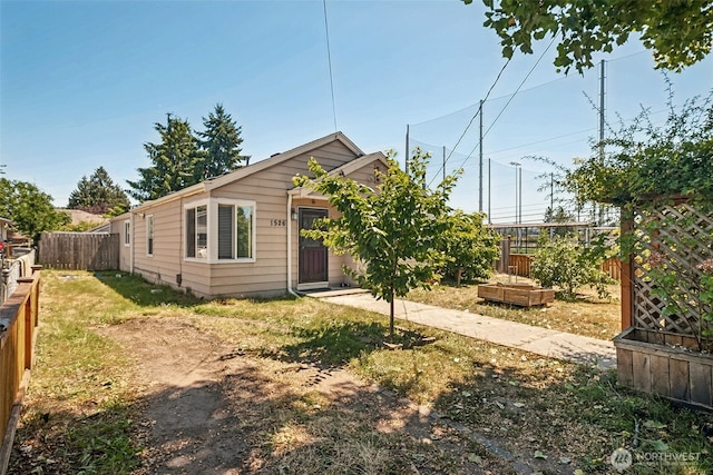 1526 H St SE, Auburn, WA 98002 - view of front facade with a vegetable garden and a fenced backyard