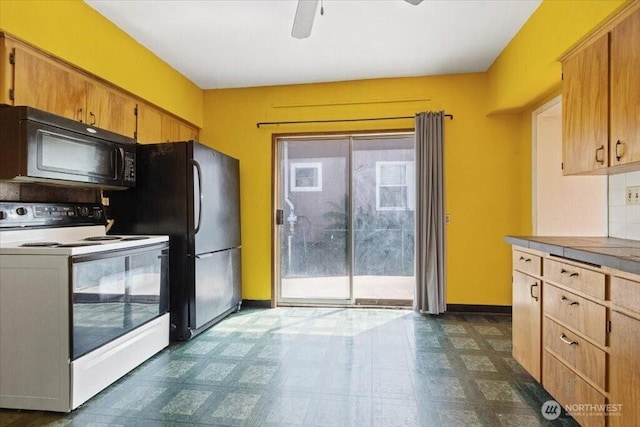 524 E 9th Ave, Spokane, WA 99202 - kitchen with black appliances, ceiling fan, dark flooring, and light countertops