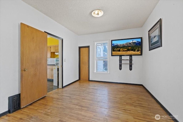 524 E 9th Ave, Spokane, WA 99202 - unfurnished room with wood finished floors and a textured ceiling