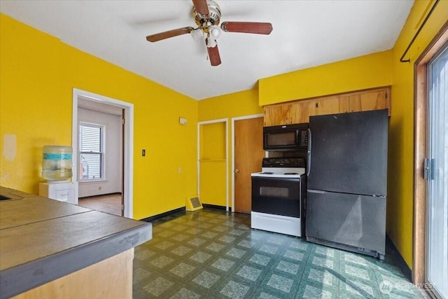 524 E 9th Ave, Spokane, WA 99202 - kitchen with black appliances, dark floors, ceiling fan, and brown cabinetry