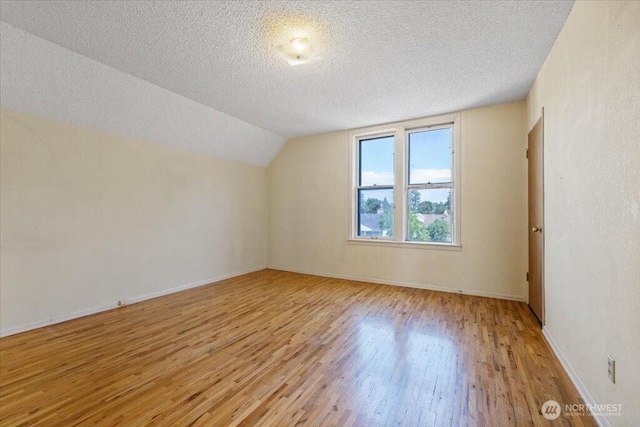 524 E 9th Ave, Spokane, WA 99202 - bonus room with light wood-style flooring, a textured ceiling, and lofted ceiling
