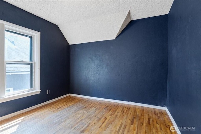 524 E 9th Ave, Spokane, WA 99202 - bonus room with lofted ceiling, wood finished floors, and a textured ceiling