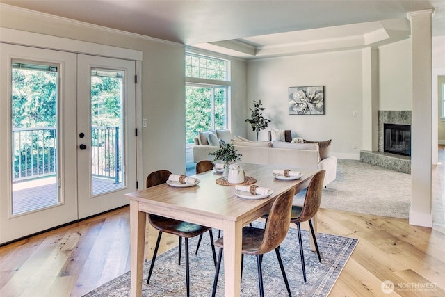 4957 Lewis Ave, Bellingham, WA 98229 - dining room featuring ornamental molding, french doors, light wood-style floors, a fireplace, and a raised ceiling