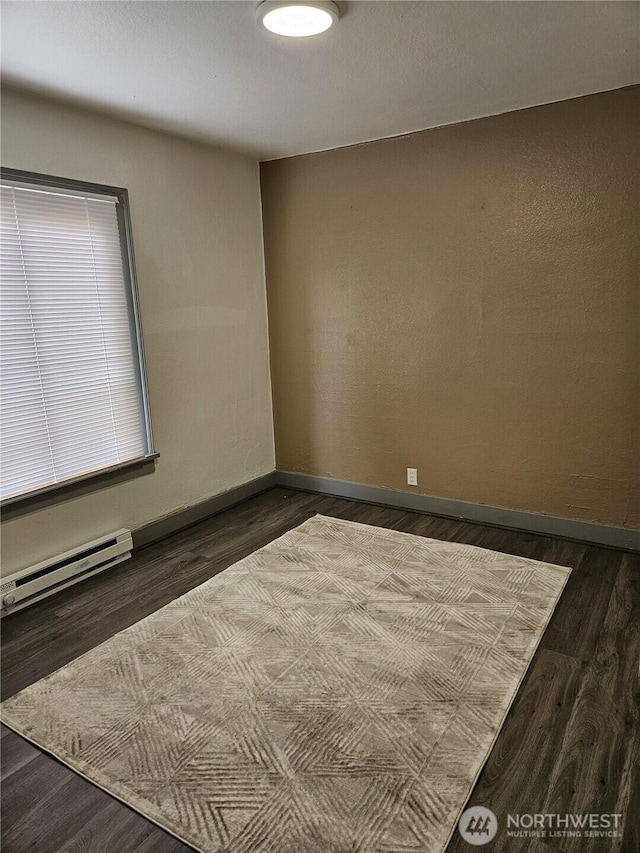 3023 Aberdeen Ave, Hoquiam, WA 98550 - unfurnished room with a baseboard radiator and dark wood-style floors