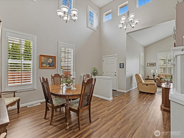 12732 69th Dr SE, Snohomish, WA 98296 - dining space featuring a chandelier, a high ceiling, wood finished floors, and plenty of natural light