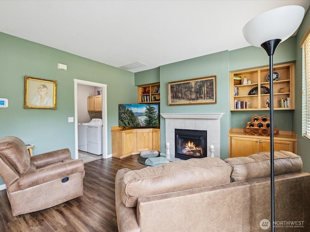 12732 69th Dr SE, Snohomish, WA 98296 - living room with washer and clothes dryer, wood finished floors, and a tile fireplace