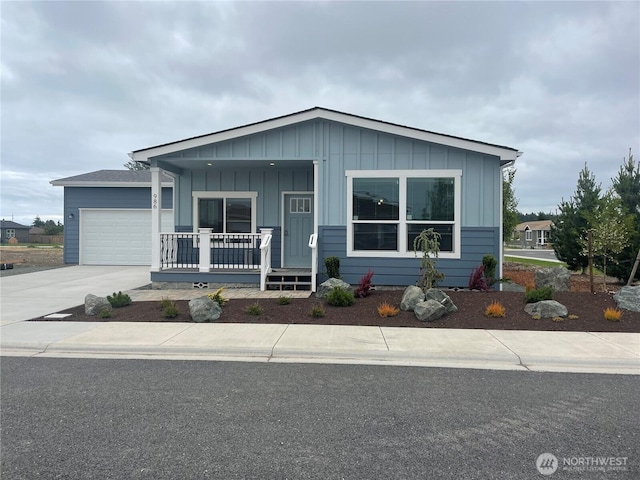 986 N Rock Rose Ave, Sequim, WA 98382 - view of front of home with a porch, board and batten siding, driveway, and a garage