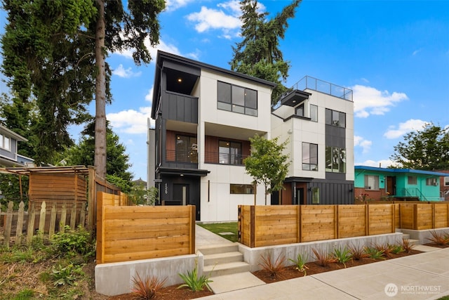 4529 S Orcas St, Seattle, WA 98118 - modern home featuring a fenced front yard and board and batten siding