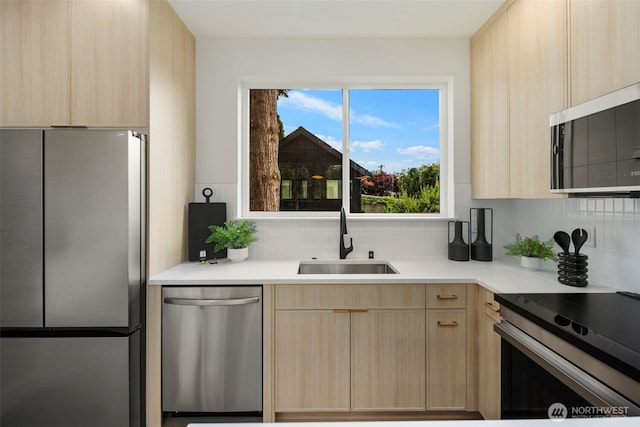 4529 S Orcas St Unit B, Seattle, WA 98118 - kitchen featuring stainless steel appliances, light brown cabinetry, modern cabinets, backsplash, and light countertops