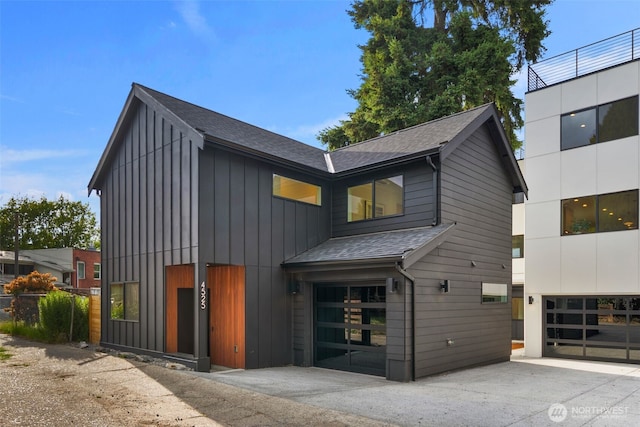 4525 S Orcas St, Seattle, WA 98118 - contemporary home with a garage, roof with shingles, board and batten siding, and driveway