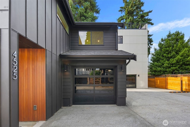4525 S Orcas St, Seattle, WA 98118 - view of exterior entry featuring board and batten siding and an attached garage