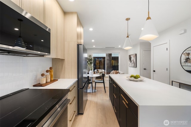 4525 S Orcas St, Seattle, WA 98118 - kitchen with stainless steel appliances, modern cabinets, light brown cabinetry, light wood-style floors, and recessed lighting