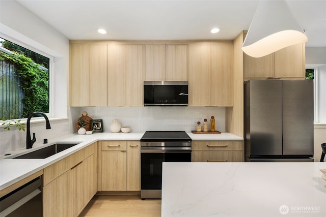 4525 S Orcas St, Seattle, WA 98118 - kitchen with appliances with stainless steel finishes, light brown cabinetry, modern cabinets, and recessed lighting