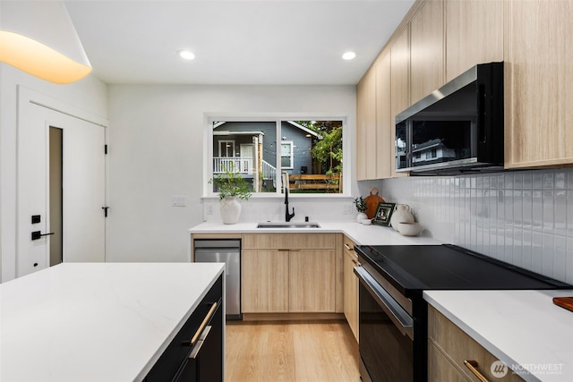 4525 S Orcas St, Seattle, WA 98118 - kitchen featuring appliances with stainless steel finishes, light brown cabinets, backsplash, light wood-style floors, and recessed lighting