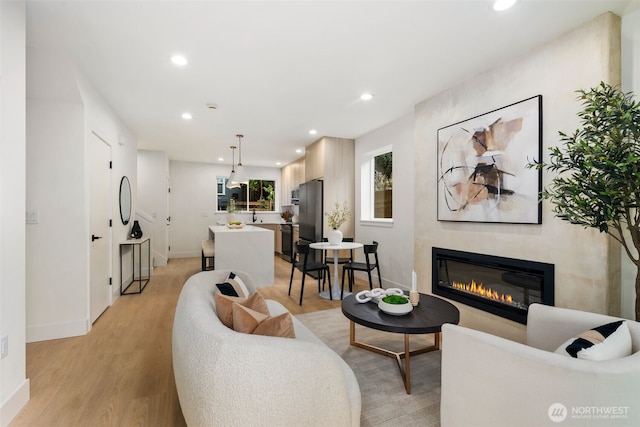 4525 S Orcas St, Seattle, WA 98118 - living room with light wood-style floors, a glass covered fireplace, and recessed lighting