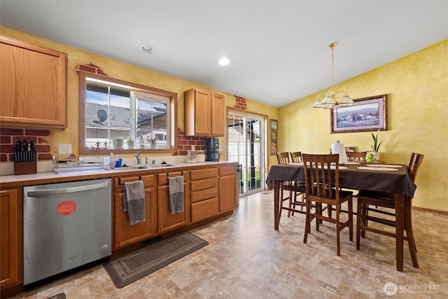 925 S 11th Ave, Othello, WA 99344 - kitchen featuring stainless steel dishwasher, lofted ceiling, a chandelier, decorative backsplash, and light countertops