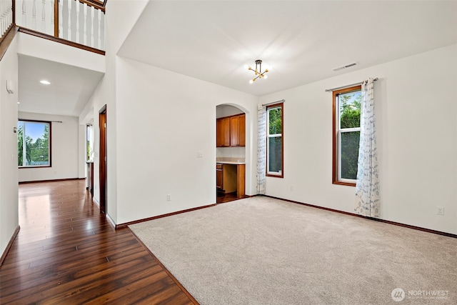 22820 41st Dr SE, Bothell, WA 98021 - spare room with arched walkways, dark wood-type flooring, and a chandelier