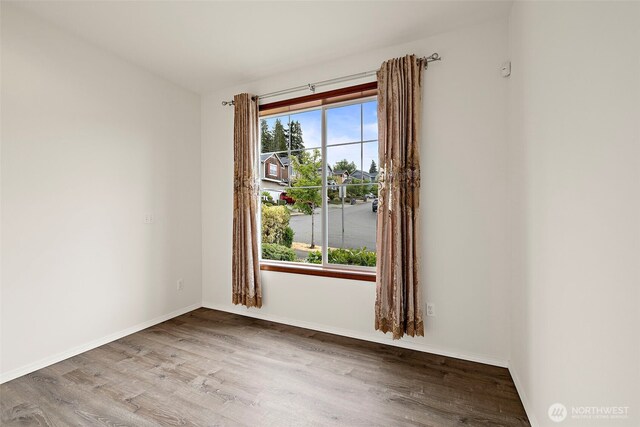 22820 41st Dr SE, Bothell, WA 98021 - empty room featuring wood finished floors and baseboards