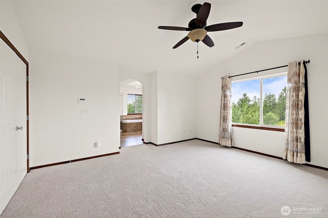 22820 41st Dr SE, Bothell, WA 98021 - spare room featuring vaulted ceiling, arched walkways, light colored carpet, and ceiling fan