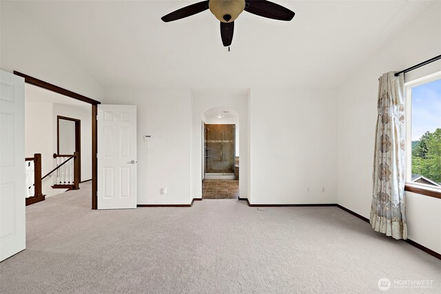 22820 41st Dr SE, Bothell, WA 98021 - unfurnished bedroom featuring carpet, arched walkways, ensuite bath, and a ceiling fan