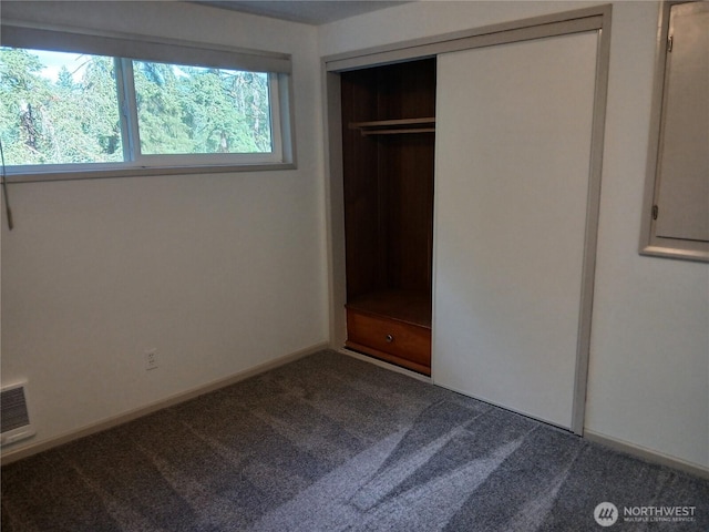 713 Wildwood Rd, Curtis, WA 98538 - unfurnished bedroom featuring dark carpet and a closet