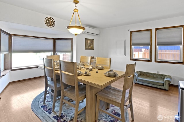 10208 D St E, Tacoma, WA 98445 - dining room featuring a wall unit AC and wood finished floors