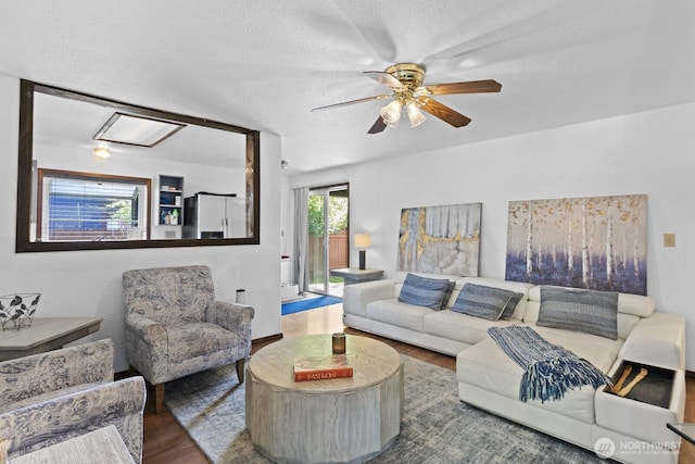 10208 D St E, Tacoma, WA 98445 - living room with wood finished floors, a ceiling fan, and a textured ceiling