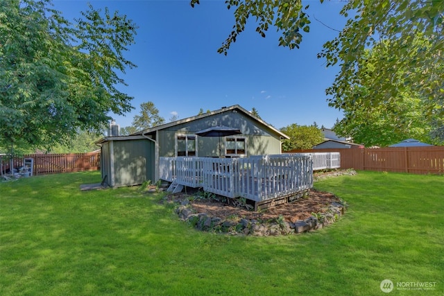 10208 D St E, Tacoma, WA 98445 - back of house featuring a fenced backyard, a wooden deck, and a chimney