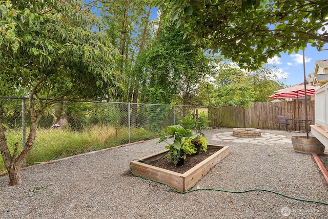 323 Helen St, Sedro Woolley, WA 98284 - fenced backyard with a fire pit and a patio area