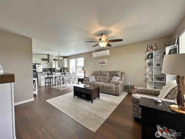 704 Roundtree Blvd, Winlock, WA 98596 - living room featuring an AC wall unit, a ceiling fan, and dark wood-style flooring